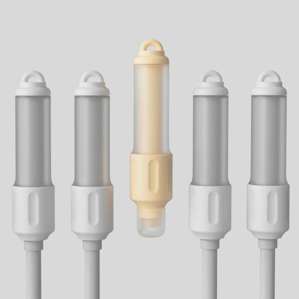 A row of Twistoo rotating erasers with one pale yellow body among grey versions