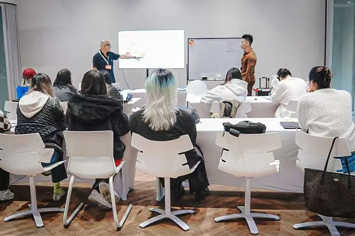 Max participating in a design-thinking discussion with an academic audience