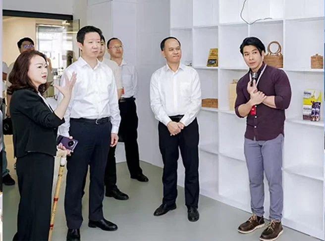 Max explaining design and innovation work to a group of visitors