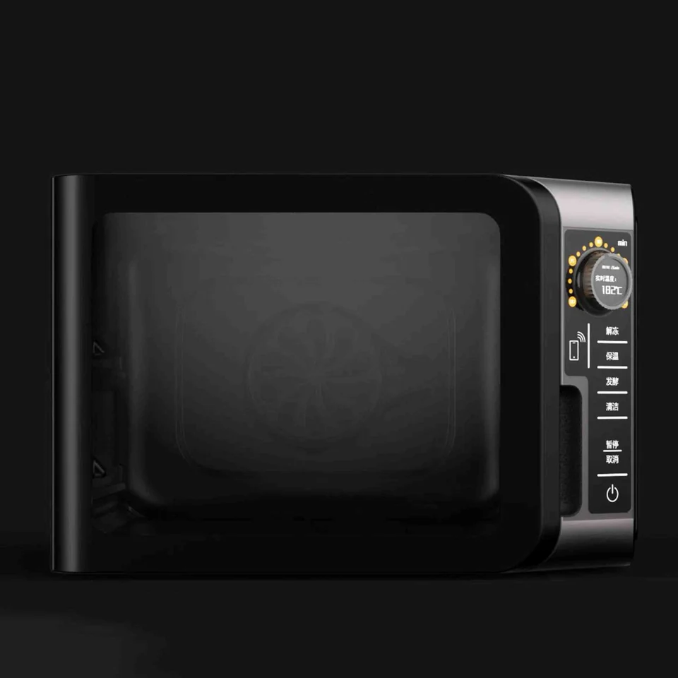 Black countertop steam oven with a dark glass door and right-side controls